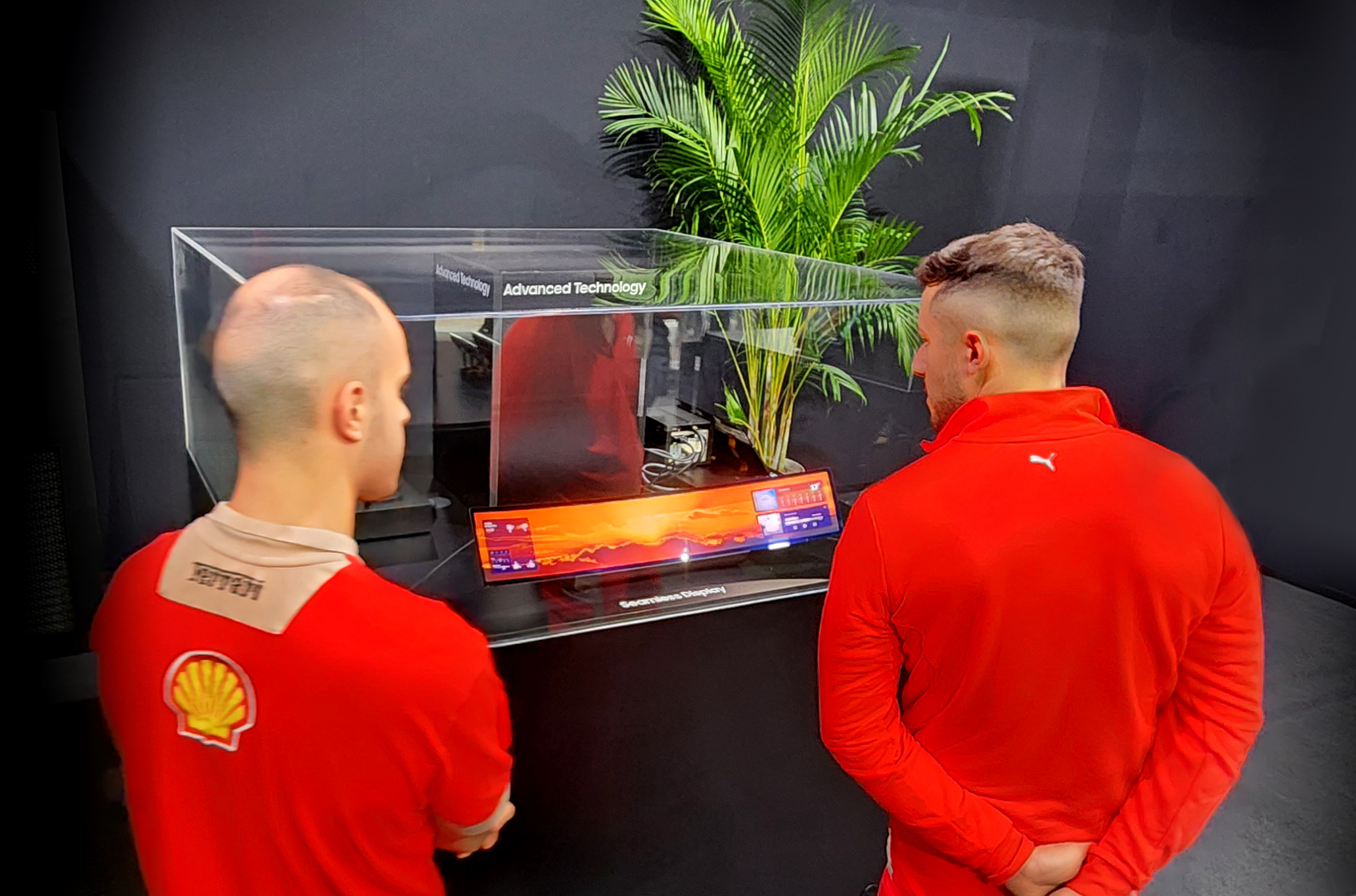 Visitors taking a look at the 34-inch wide OLED at Samsung Display's booth