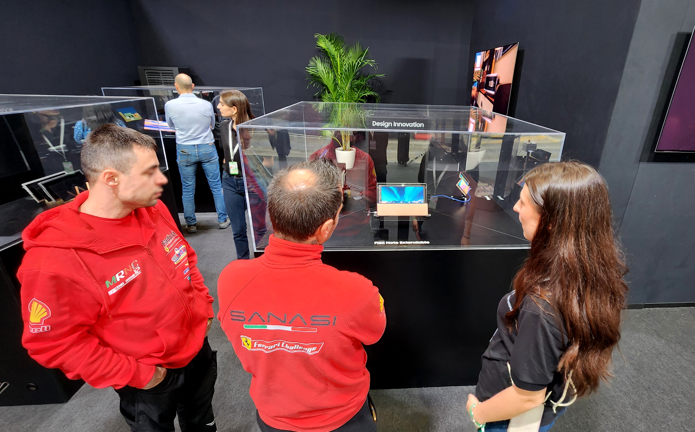 Visitors exploring foldable and slidable OLED products at Samsung Display's booth